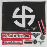 A quantity of assorted reproduction militaria; 1x flag, 2x cuff titles, 4x badges,1x cloth eagle,