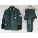 A reproduction WWII German Combat Jacket with rank and medal, with breeches.