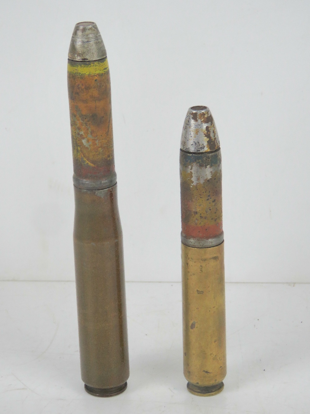 Two inert German 20mm shells, having markings upon.