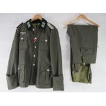 A reproduction WWII German Combat Tunic (XXXL) and breeches.