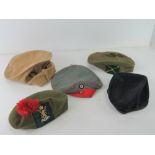 Five assorted military caps.