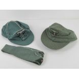 A reproduction WWII German side cap together with two reproduction ski hats.