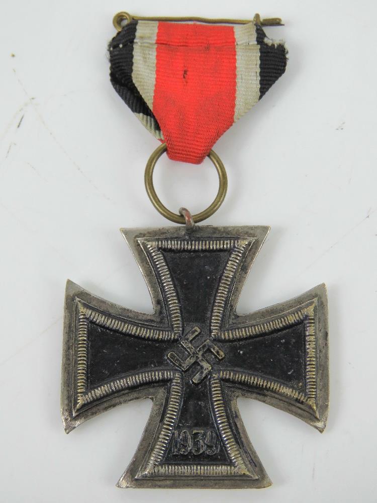 A reproduction WWII German Iron Cross with ribbon.