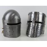 Two reenactors medieval style knights helmets.