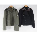 A replica German SS Panzer tunic. Size 41 together with a replica German Combat Tunic Size XXXL.