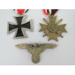 Two reproduction WWII German medals, together with a reproduction badge. Three items.