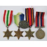 Four WWII British medals together with one Dog tag.