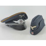 A reproduction WWII German visor cap, together with a reproduction WWII German side cap.