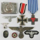 A quantity of reproduction WWII German items including belt buckle, cloth badge, medals, etc.
