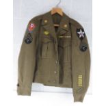 A WWII US Ike Jacket with insignia, size 36R.