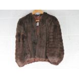 A vintage faux fur shrug, slight damage to left shoulder noted.