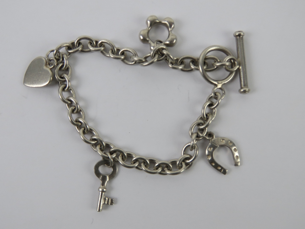 A HM silver charm bracelet having T-bar