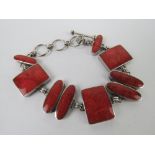 A silver and faux coral bracelet, oval a