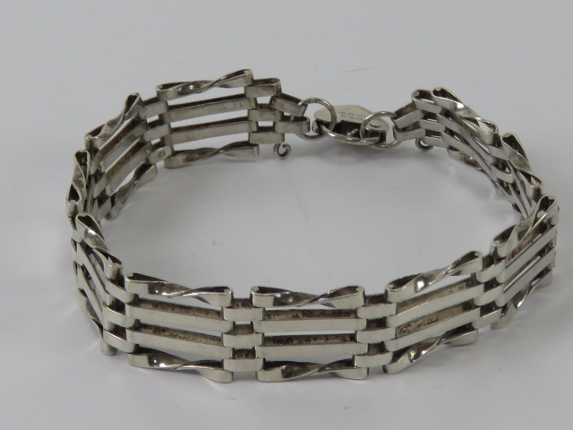 A silver gate link bracelet having Londo