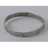 A HM silver bangle having overlapping ov