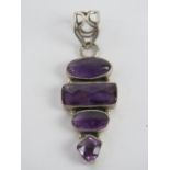 A silver and amethyst pendant having thr