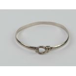 A HM silver bangle having knot and hook