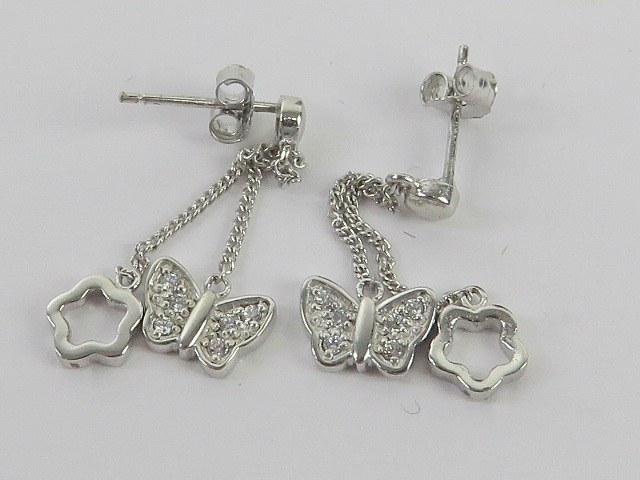 A pair of silver butterfly and floral dr