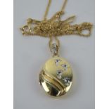 A silver and gold plated locket having f