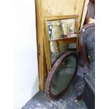 A LARGE EDWARDIAN OVAL MIRROR, AND A GILT FRAMED WALL MIRROR.