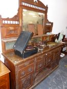 A VICTORIAN MAHOGANY CARVED OAK MIRROR BACKED SIDE BOARD.