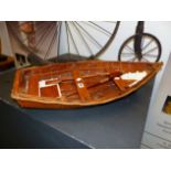 A MODEL ROWBOAT WITH CLINKER HULL 75 CM LONG