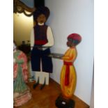 TWO PAINTED EASTERN FIGURES HOLDING TRAYS AS SILENT BUTLERS/ DUMB WAITERS TALLEST 120 CM HIGH