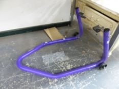 A MOTORCYCLE PADDOCK STAND.