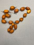 A VINTAGE AMBER OVAL BEADED NECKLACE, THREADED ON METAL WOVEN WIRE.