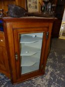 A GLAZED OAK CORNER CABINET