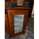 A GLAZED OAK CORNER CABINET