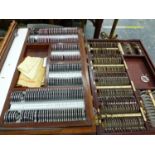 THREE WOODEN BOXES OF LENSES AND OPTICIANS EQUIPMENT, A WEISS CASE OF ROUND HEADED PINS IN THREE