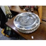 TEN SMALL SILVER PLATED ARMORIAL PLATTERS.