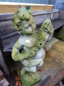 A CHERUB GARDEN FIGURE.