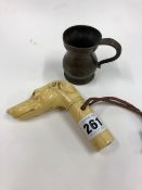 AN ART DECO DOGS HEAD PARASOL HANDLE, AND A SMALL BRONZE MEASURE.