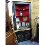 AN ANTIQUE EBONISED CHINOISERIE CORNER CABINET.