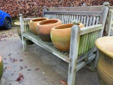 A SLAT BACK HARDWOOD GARDEN BENCH