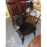 AN EBONIZED SPINDLE BACK ARMCHAIR.