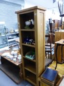 A TALL MODERN OAK BOOKCASE SHELF UNIT, AND A LOW BOX OTTOMAN COFFEE TABLE.