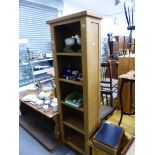 A TALL MODERN OAK BOOKCASE SHELF UNIT, AND A LOW BOX OTTOMAN COFFEE TABLE.