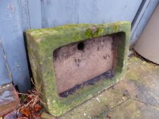 AN ANTIQUE CARVED STONE SINK