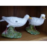 A PAIR OF GLAZED POTTERY FIGURES OF WADING BIRDS