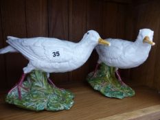 A PAIR OF GLAZED POTTERY FIGURES OF WADING BIRDS