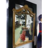 A FRENCH STYLE CARVED AND GILT FRAMED MIRROR WITH SWAG DECORATION 70 X 110 CM