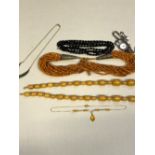 A GRADUATED ROW OF OVAL AMBER BEADS, TOGETHER WITH A GREEN HARD STONE NECKLET, BLACK FACETED