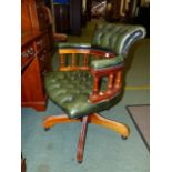 A BUTTON GREEN LEATHER UPHOLSTERED OFFICE SWIVEL ARMCHAIR