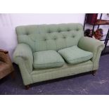 A LATE VICTORIAN DROP END BUTTON BACK SETTEE.