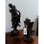 TWO CHINESE CARVED HARDWOOD FIGURES, ONE OF A SKINNY MAN SEATED. H 28cms. THE OTHER OF A