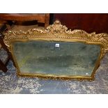 A GILDED FRAME DECORATIVE WALL MIRROR.