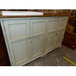 A LARGE VICTORIAN PAINTED PINE AND OAK FOUR DOOR CABINET.